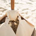 Olairo Conch Connector attaching umbrella to Blossom Base on beach