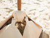 Olairo Conch Connector attaching umbrella to Blossom Base on beach