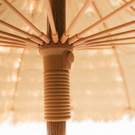 Close-up of a natural umbrella with a ribbed handle on a button release runner