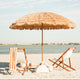 A natural beach umbrella and a luxury beach setup.