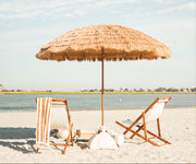 A natural beach umbrella and a luxury beach setup.